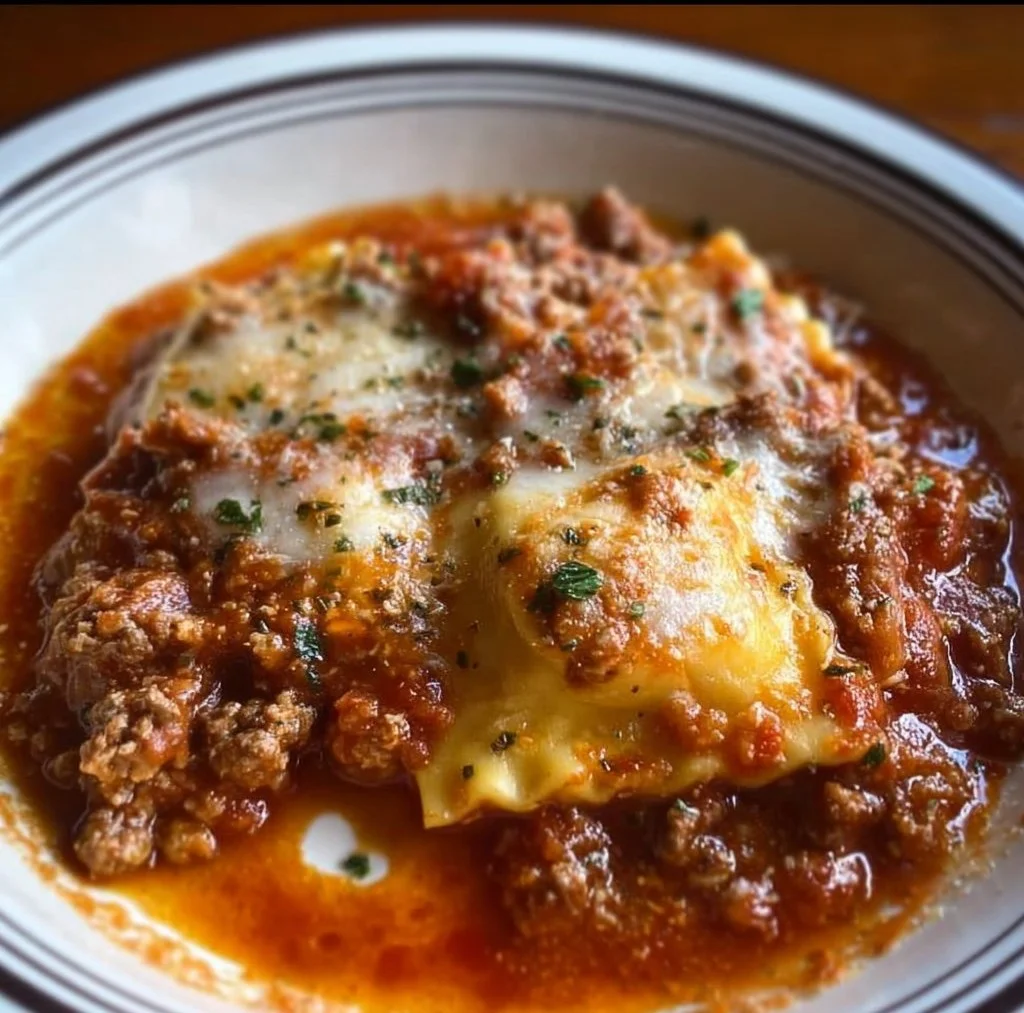 Delicious Crockpot Ravioli Lasagna layered with cheese and sauce in a slow cooker.
