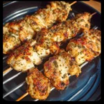 Garlic Parmesan Chicken skewers grilled to perfection, garnished and served.