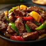 Sizzling Chinese pepper steak with onions served on a plate
