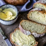 Loaf of Traditional Irish Soda Bread on a wooden cutting board