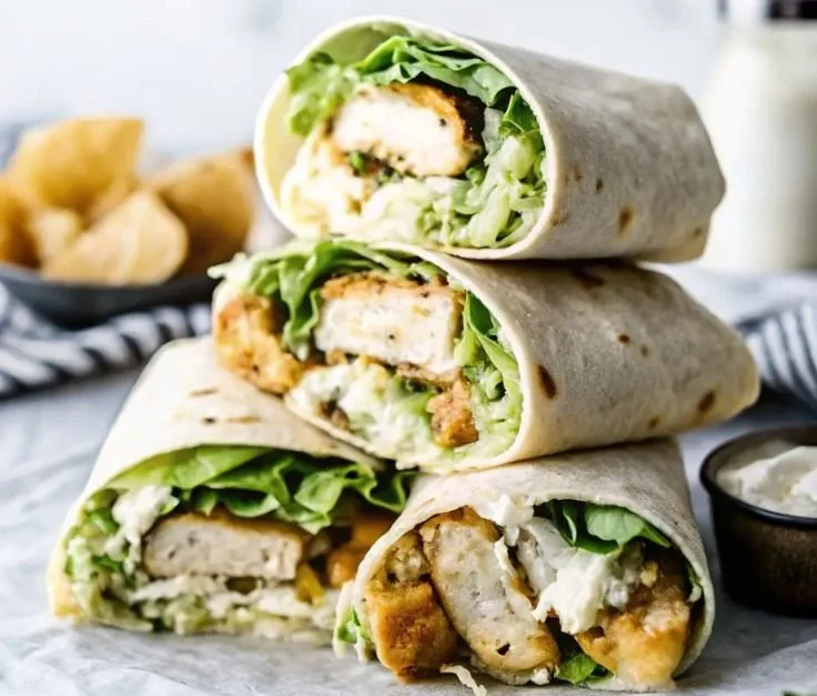 Delicious Chicken Caesar Wraps with lettuce, grilled chicken, and Caesar dressing