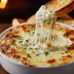 Creamy garlic bread dip served with crispy breadsticks.