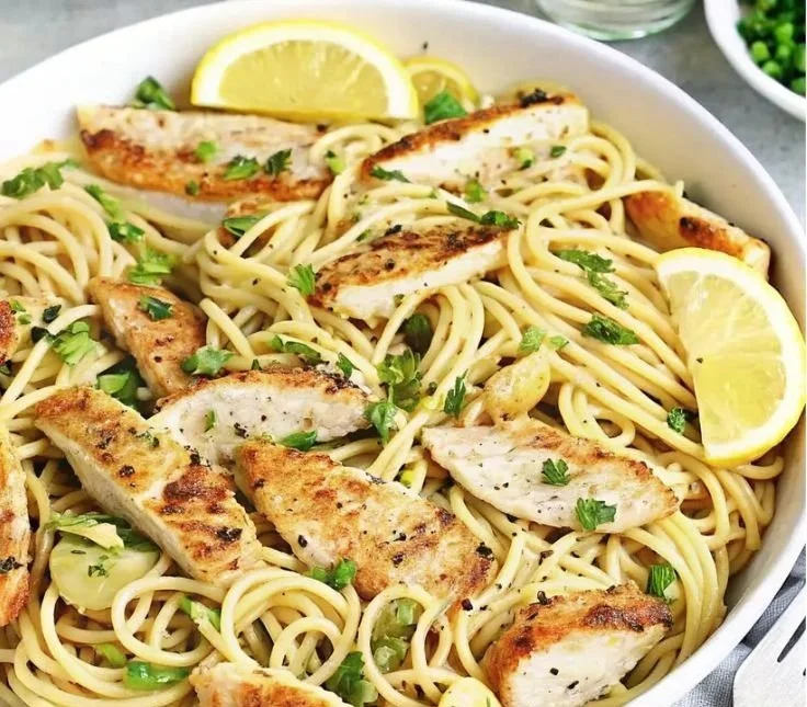 Creamy Lemon Chicken Pasta 3 Bowl of creamy lemon chicken pasta with herbs and lemon slices