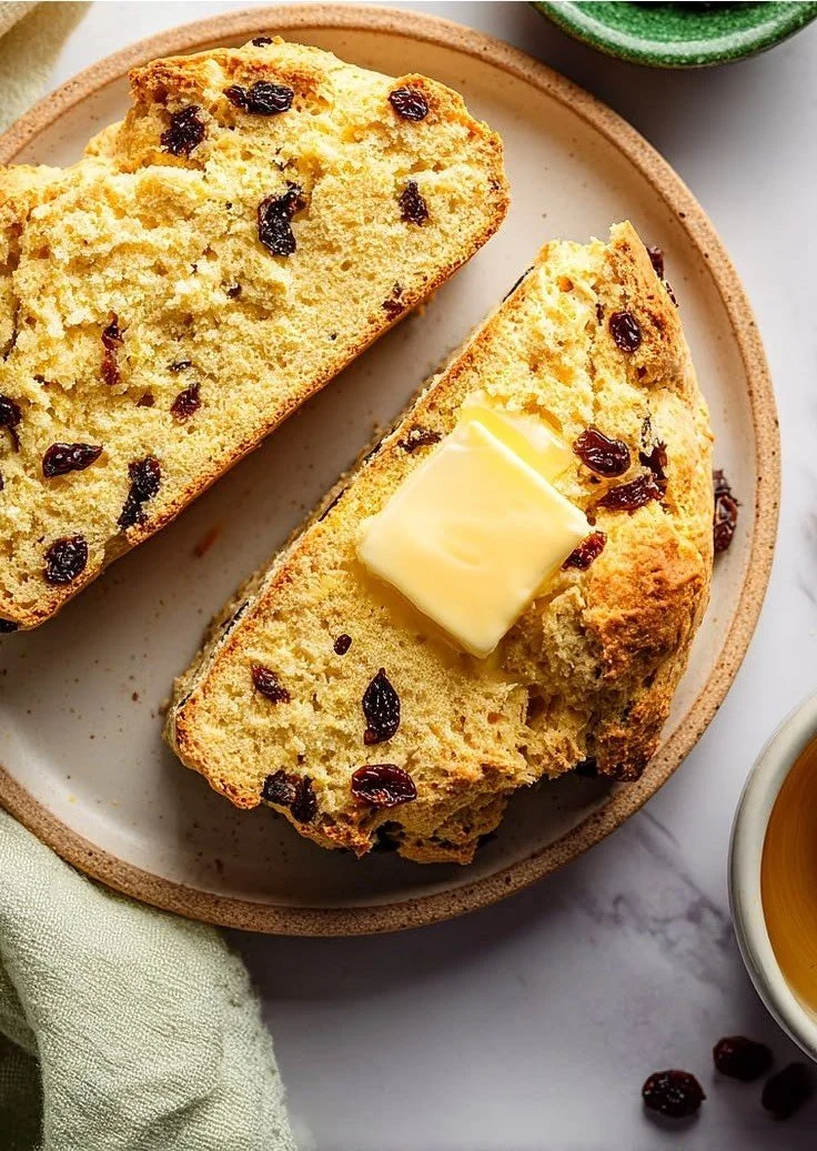 Loaf of easy Irish soda bread with currants on a rustic wooden table