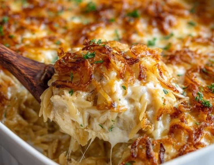 French onion chicken orzo casserole topped with melted cheese