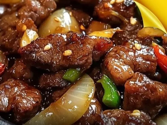 Sizzling Chinese pepper steak with onions served in a traditional plate