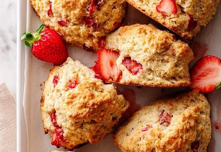 Freshly baked vegan strawberry scones on a wooden table