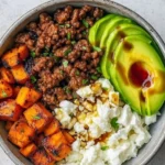 Viral Hot Honey Ground Beef Bowl topped with fresh herbs and spicy drizzle