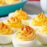 Delicious classic deviled eggs garnished with paprika and herbs