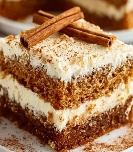 Healthy carrot cake slice topped with cream cheese frosting and walnuts